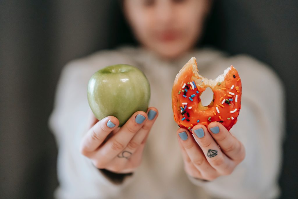 An image of an apple and a glazed doughnut.  Do fad diets really work?